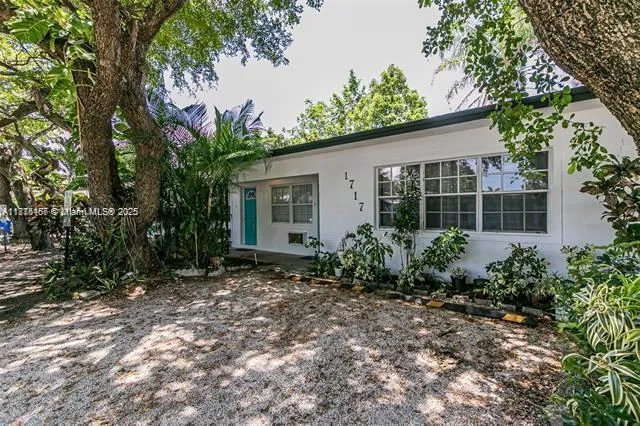 a view of a house with garden and plants