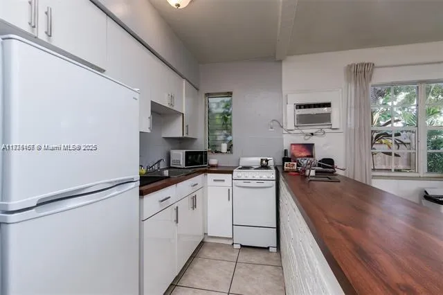 a kitchen with cabinets a sink and appliances