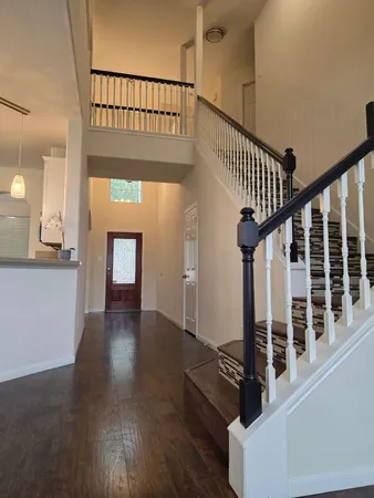 wooden floor with windows and stairs