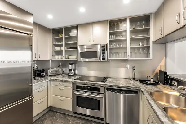 a kitchen with stainless steel appliances granite countertop a stove and a sink