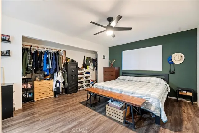 a bed room with a bed and a ceiling fan