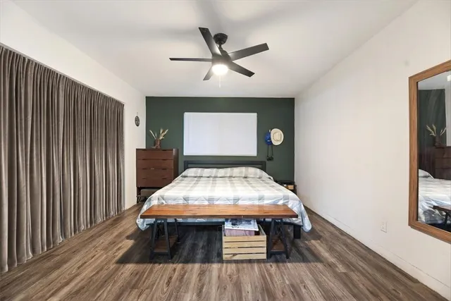 a living room with wooden floor furniture and a window