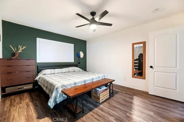 a bedroom with a bed and a dresser