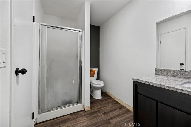 a bathroom with a granite countertop sink toilet and shower