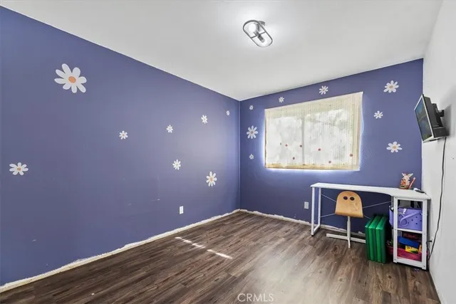 a view of workspace with furniture and wooden floor