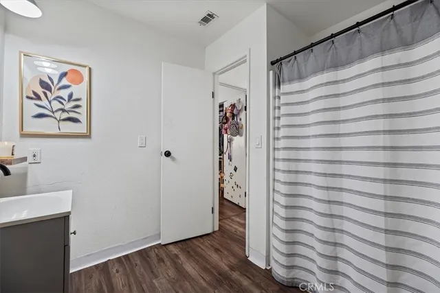 a view of a hallway with wooden floor and entryway