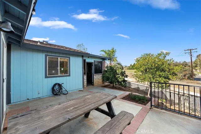 a backyard of a house with table and chairs