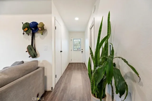 a view of a hallway with wooden floor
