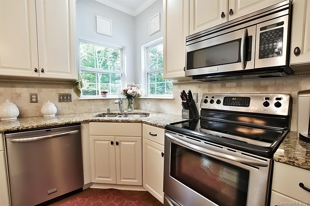 735 West Cheval Drive Fort Mill, SC 29708 - Photo 11 of 41 a kitchen with granite countertop a stove microwave and sink