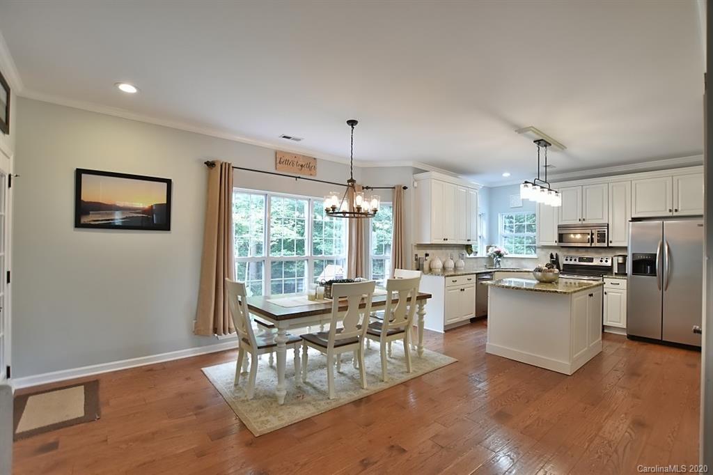 735 West Cheval Drive Fort Mill, SC 29708 - Photo 13 of 41 a view of a dining room with furniture large window and stainless steel appliances