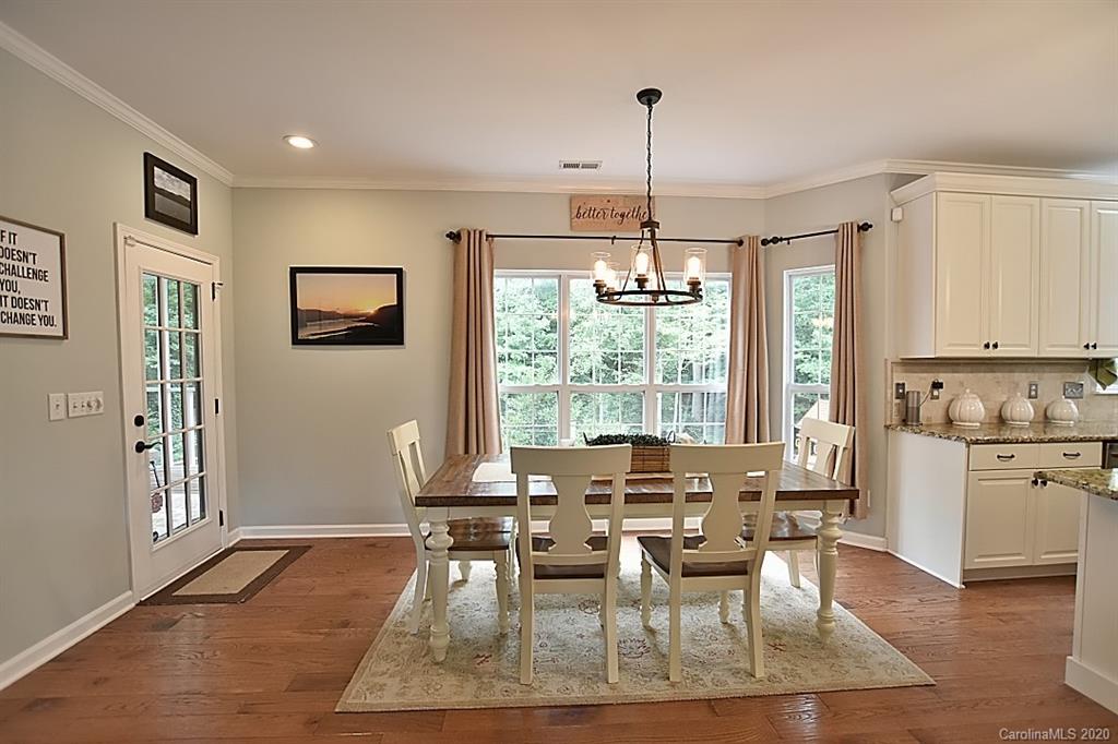 735 West Cheval Drive Fort Mill, SC 29708 - Photo 14 of 41 a dining room with furniture a chandelier and wooden floor