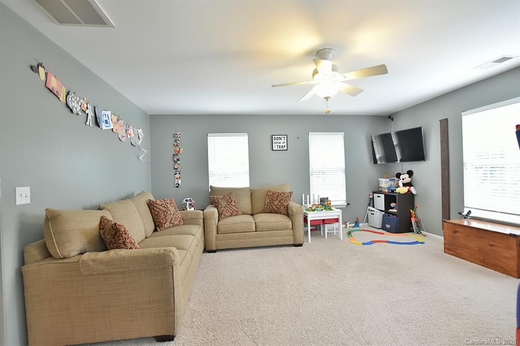735 West Cheval Drive Fort Mill, SC 29708 - Photo 26 of 41 a living room with furniture and a flat screen tv