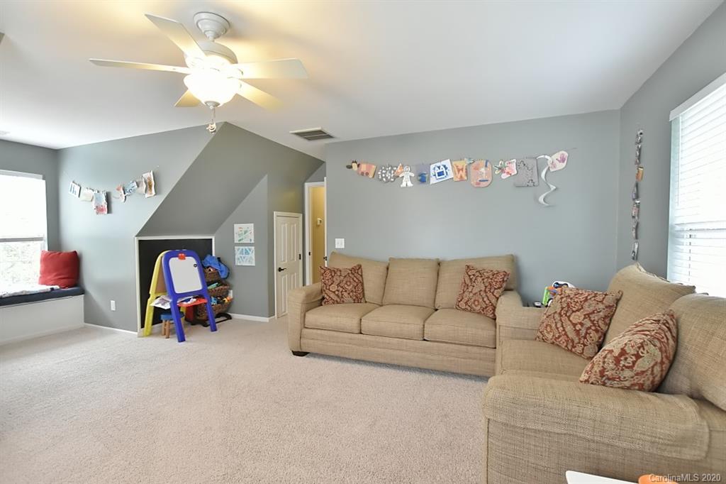 735 West Cheval Drive Fort Mill, SC 29708 - Photo 27 of 41 a living room with furniture white walls and a chandelier