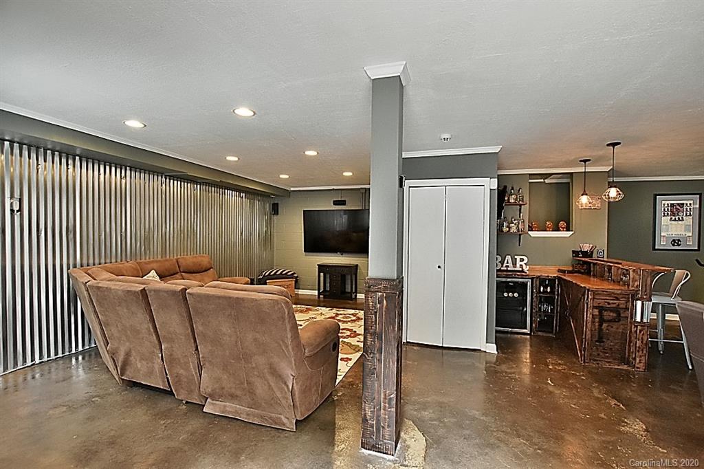 735 West Cheval Drive Fort Mill, SC 29708 - Photo 29 of 41 a living room with furniture a flat screen tv and kitchen view