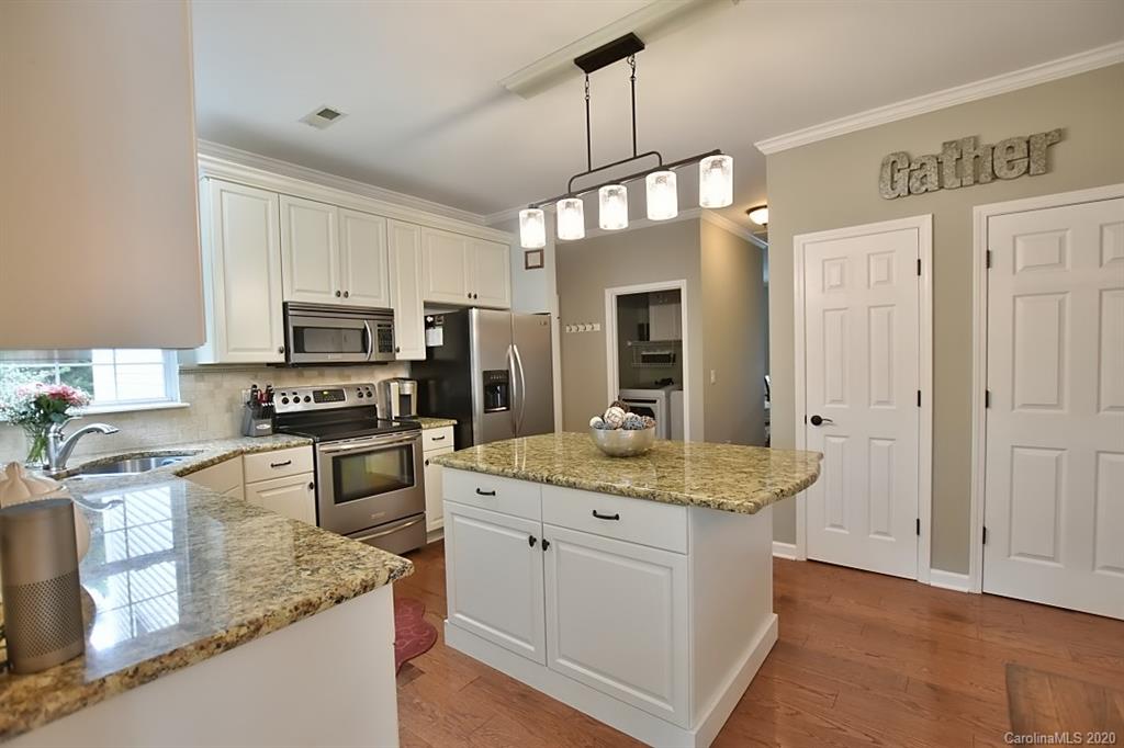 735 West Cheval Drive Fort Mill, SC 29708 - Photo 9 of 41 a kitchen with stainless steel appliances granite countertop a sink a stove top oven a counter space and cabinets