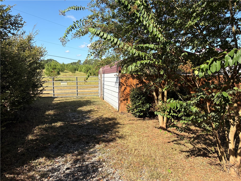 1108 Trotter Road Anderson, SC 29626 - Photo 22 of 27 Gravel drive leads past a secure outbuilding to open rolling pastures.