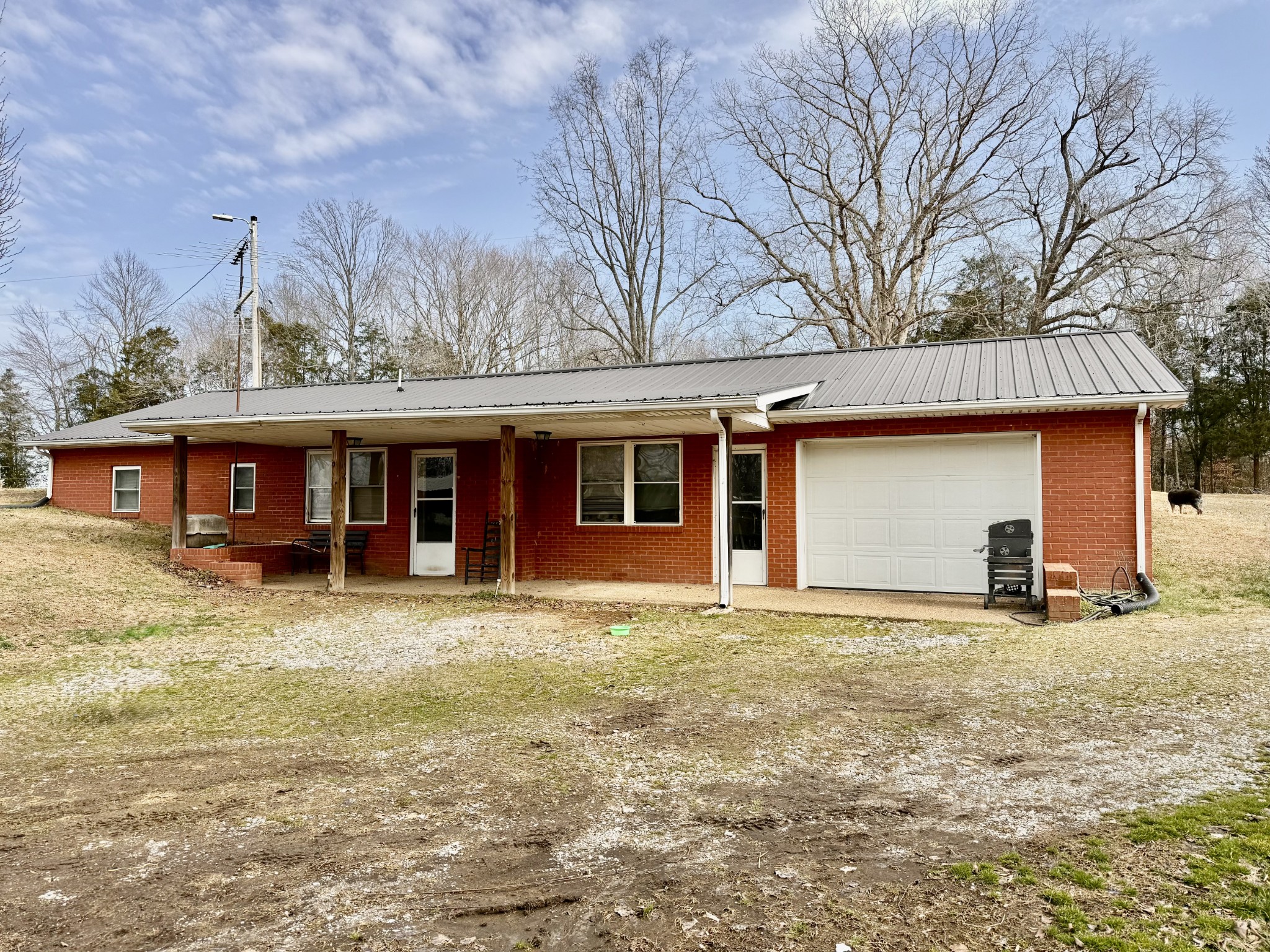 1245 Beech Grove Road Lafayette, TN 37083 - Photo 1 of 17 a view of a yard in front of a house with large tree