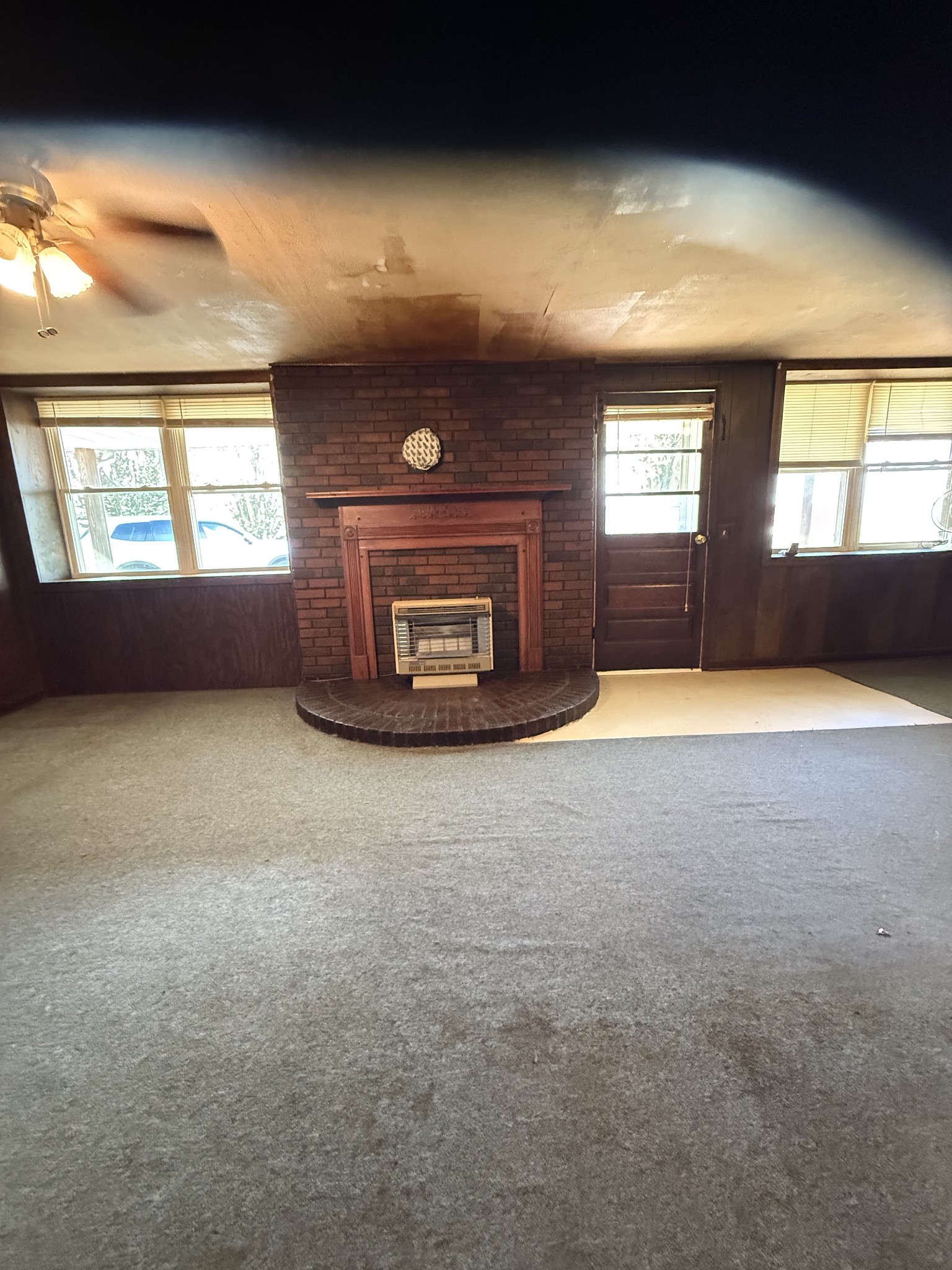 1245 Beech Grove Road Lafayette, TN 37083 - Photo 5 of 17 an empty room with a fireplace and windows