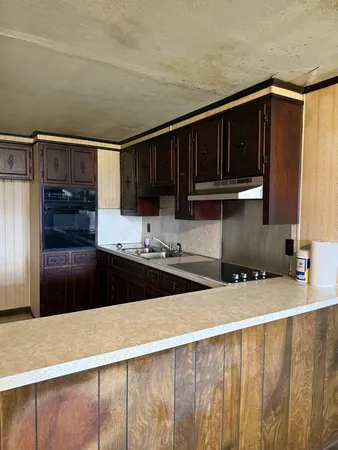 a kitchen with a sink and a refrigerator