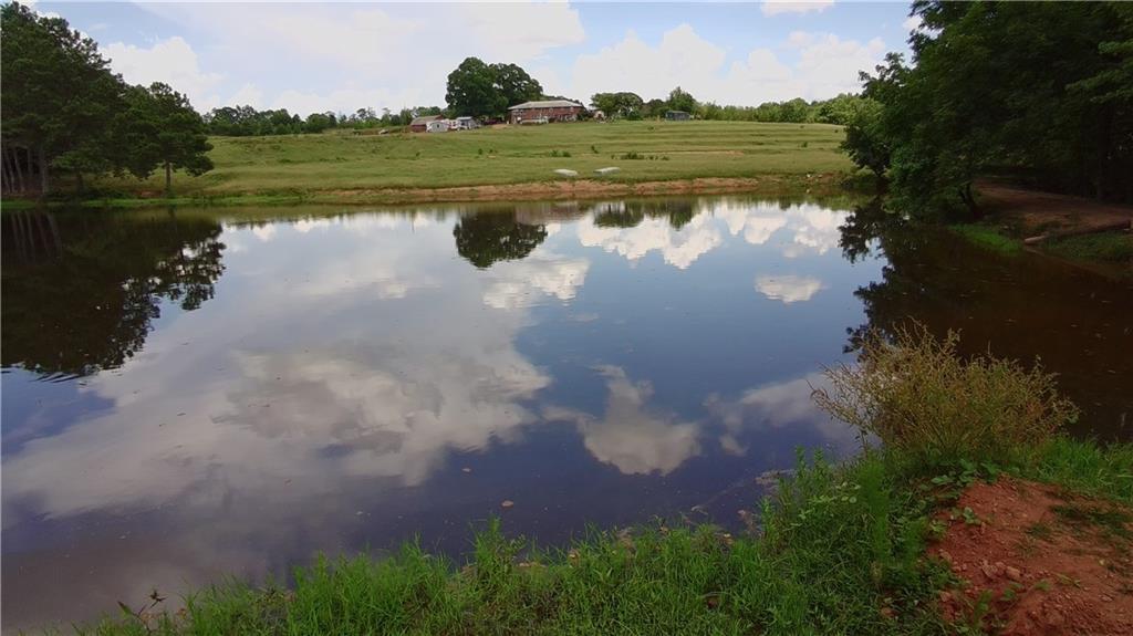 876 Simpson Mill Road Locust Grove, GA 30248 - Photo 13 of 40 a view of a lake with a yard