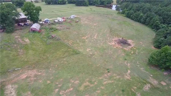 an aerial view of a residential houses with outdoor space and swimming pool