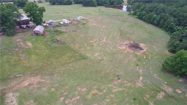 a view of a field with trees in the background