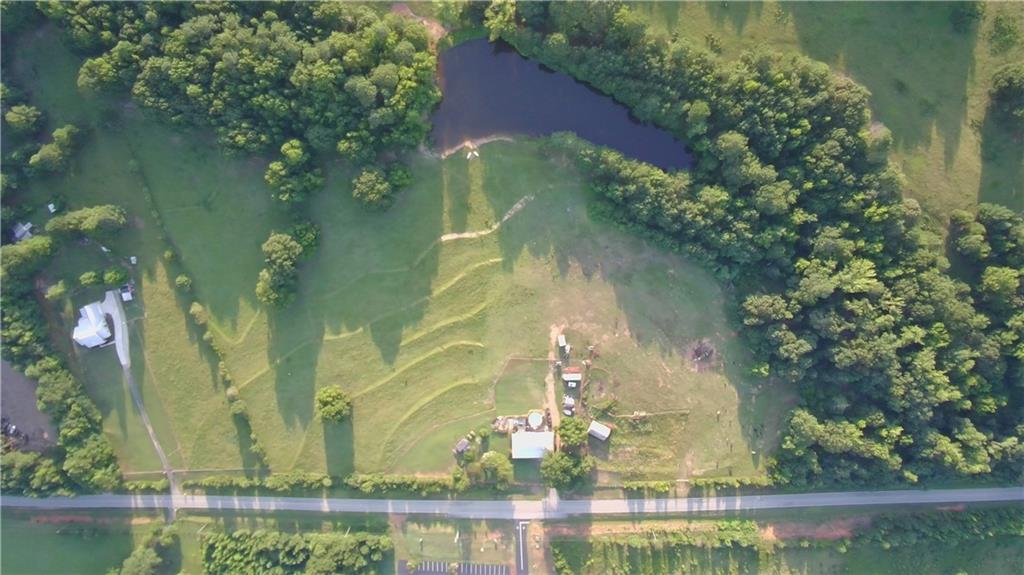 876 Simpson Mill Road Locust Grove, GA 30248 - Photo 18 of 40 an aerial view of a residential houses with outdoor space and swimming pool