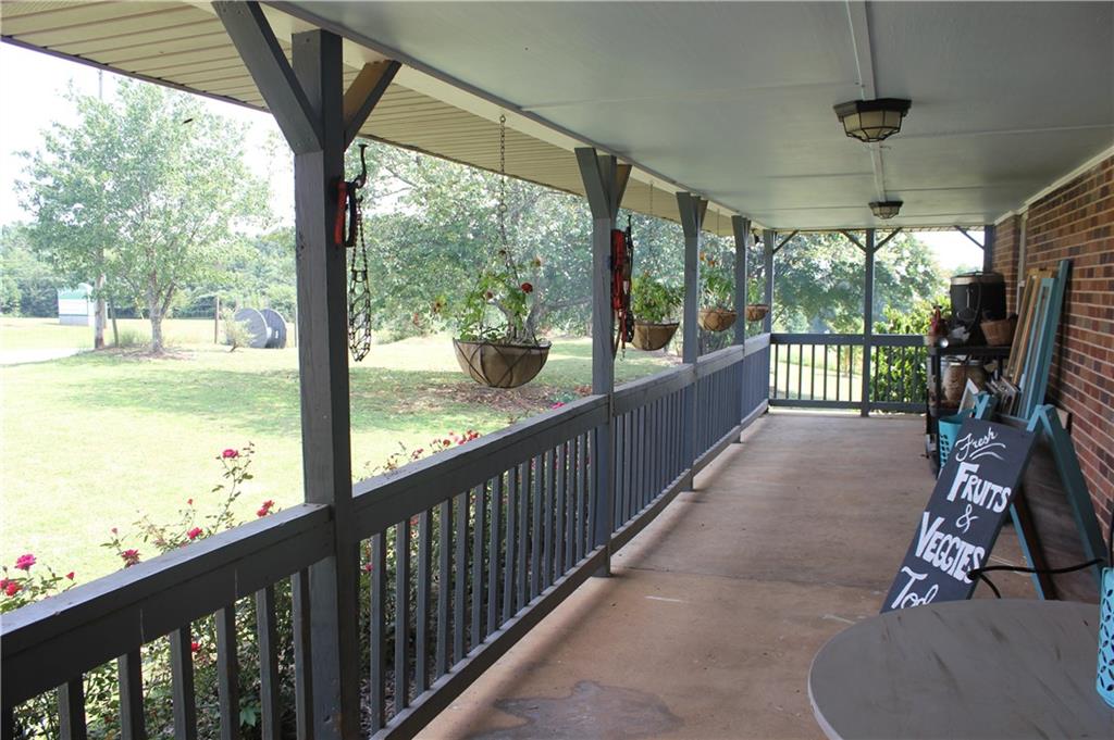 876 Simpson Mill Road Locust Grove, GA 30248 - Photo 2 of 40 a view of a porch with wooden floor of a house