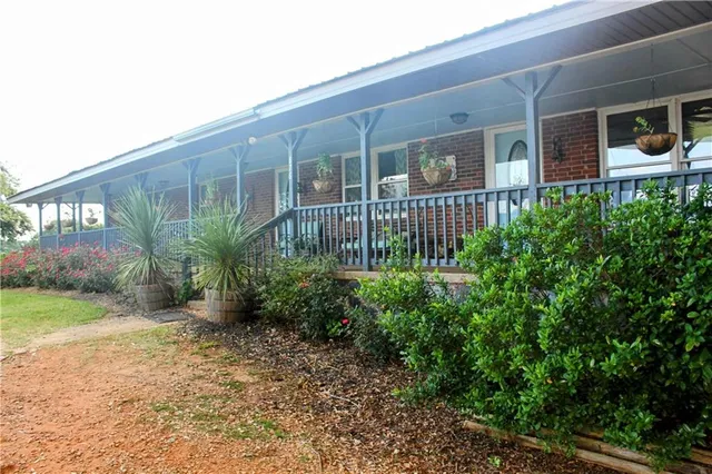 an outdoor space with lots of trees and barbeque oven
