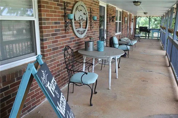 a view of a porch with chairs and couches