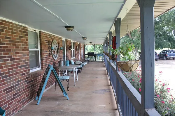 an outdoor space with lots of trees and barbeque oven