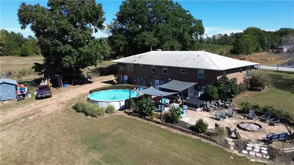 an aerial view of a house with swimming pool and outdoor space