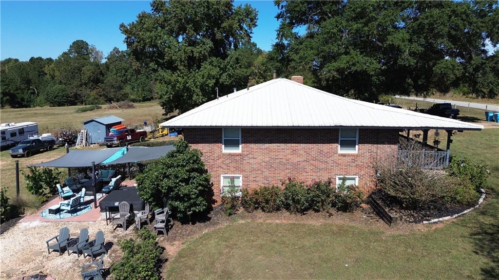 876 Simpson Mill Road Locust Grove, GA 30248 - Photo 29 of 40 an outdoor space with lots of trees and barbeque oven