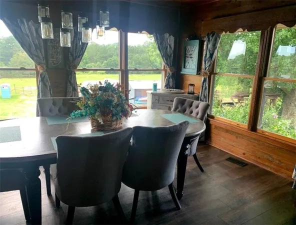 a dining room with furniture window and wooden floor