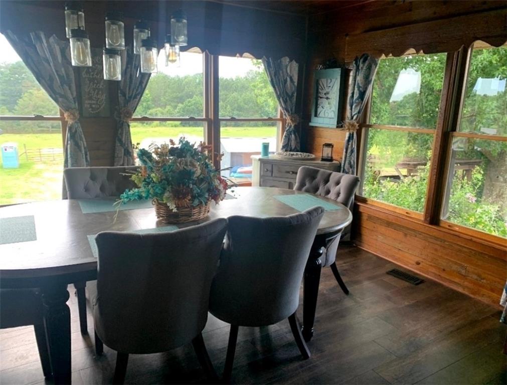 876 Simpson Mill Road Locust Grove, GA 30248 - Photo 5 of 40 a dining room with furniture window and wooden floor