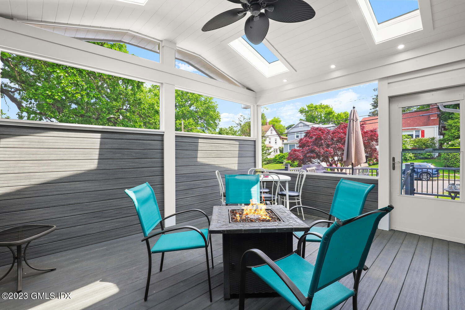 5 Oxer Place Greenwich, CT 06830 - Photo 16 of 37 a view of a patio with a dining table and chairs