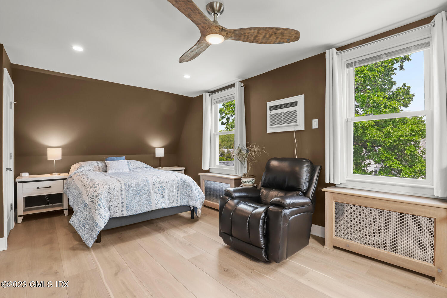 5 Oxer Place Greenwich, CT 06830 - Photo 20 of 37 a bedroom with a bed and wooden floor