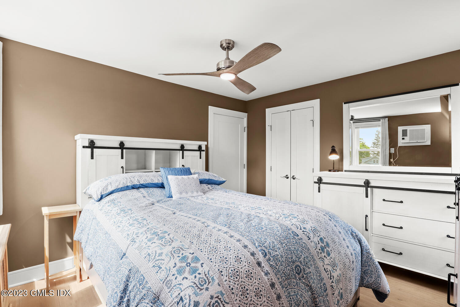 5 Oxer Place Greenwich, CT 06830 - Photo 23 of 37 a bedroom with a large bed and a chandelier