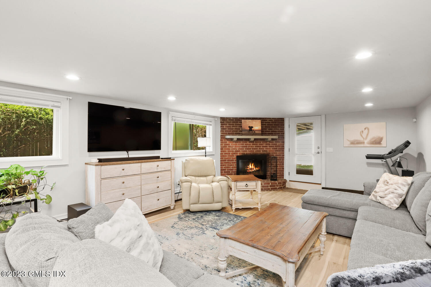 5 Oxer Place Greenwich, CT 06830 - Photo 25 of 37 a living room with furniture a flat screen tv and a fireplace