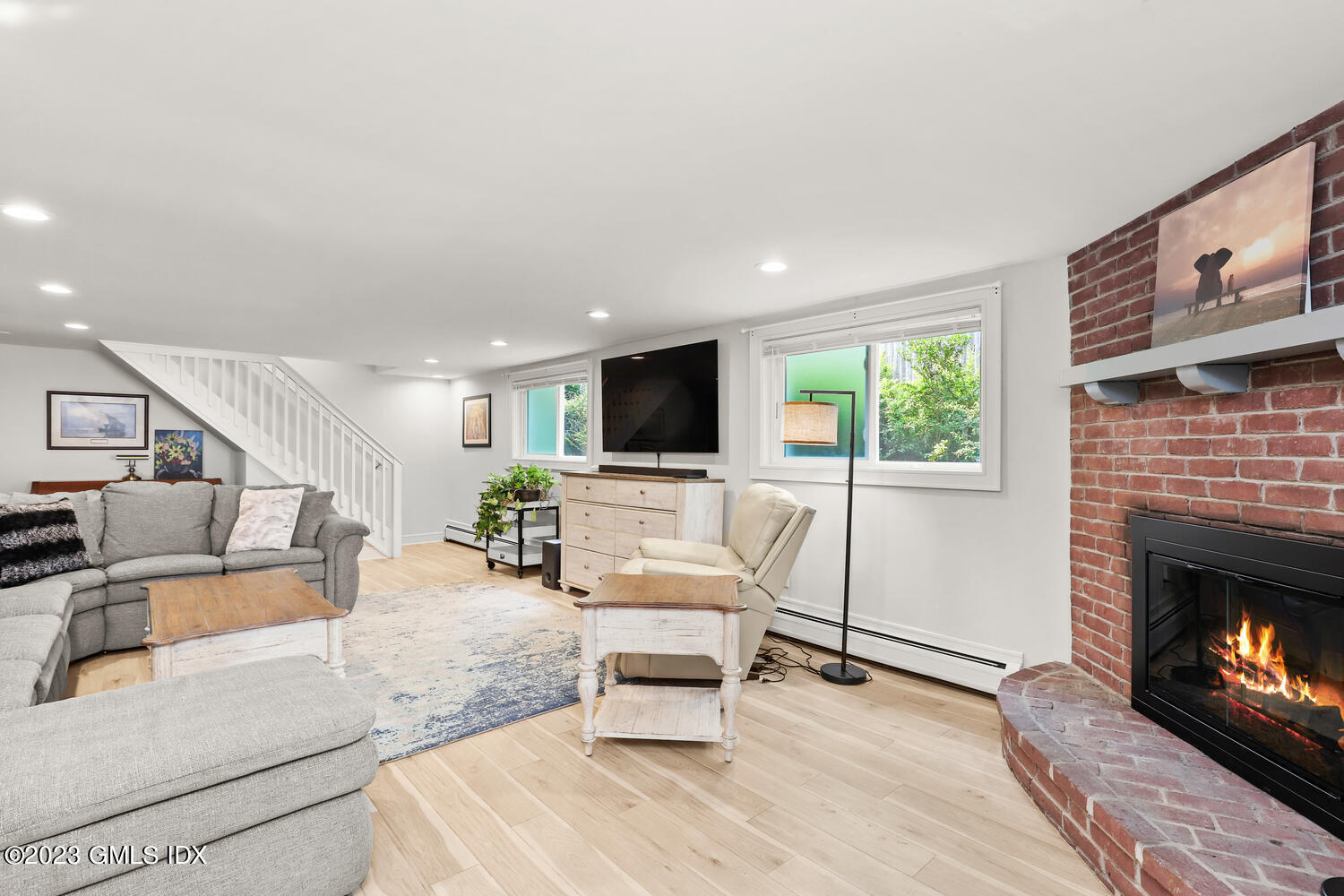 5 Oxer Place Greenwich, CT 06830 - Photo 27 of 37 a living room with furniture a flat screen tv and a fireplace