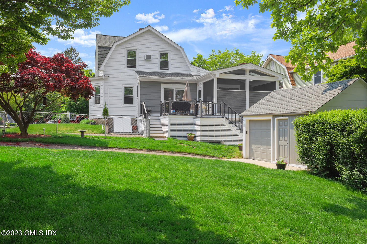 5 Oxer Place Greenwich, CT 06830 - Photo 33 of 37 a front view of a house with a yard and porch
