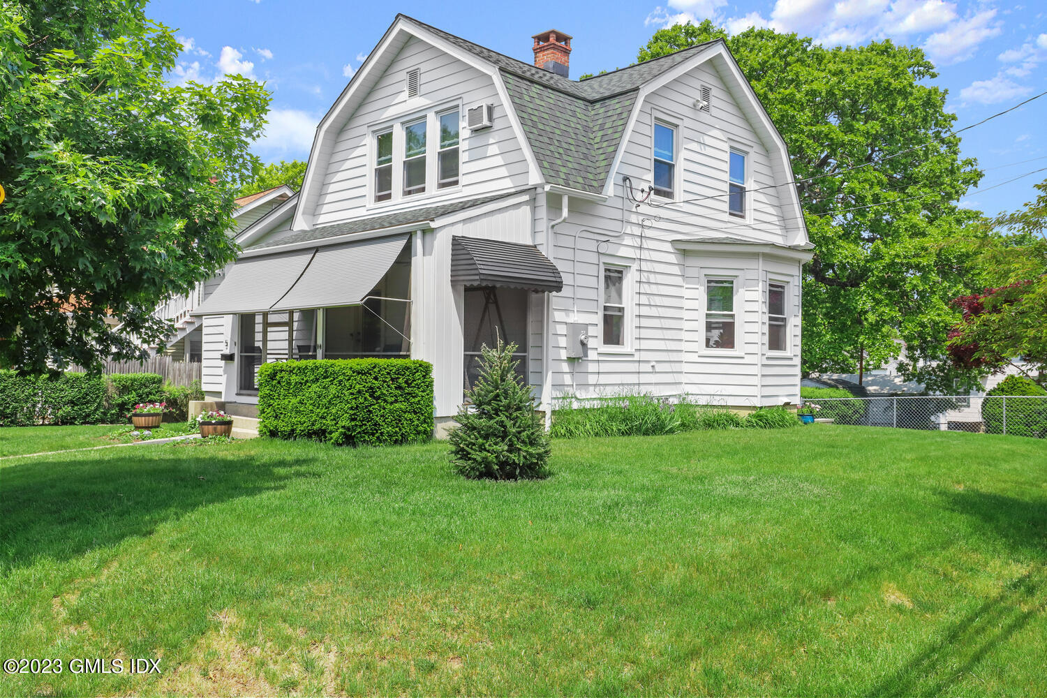 5 Oxer Place Greenwich, CT 06830 - Photo 34 of 37 a front view of a house with a garden