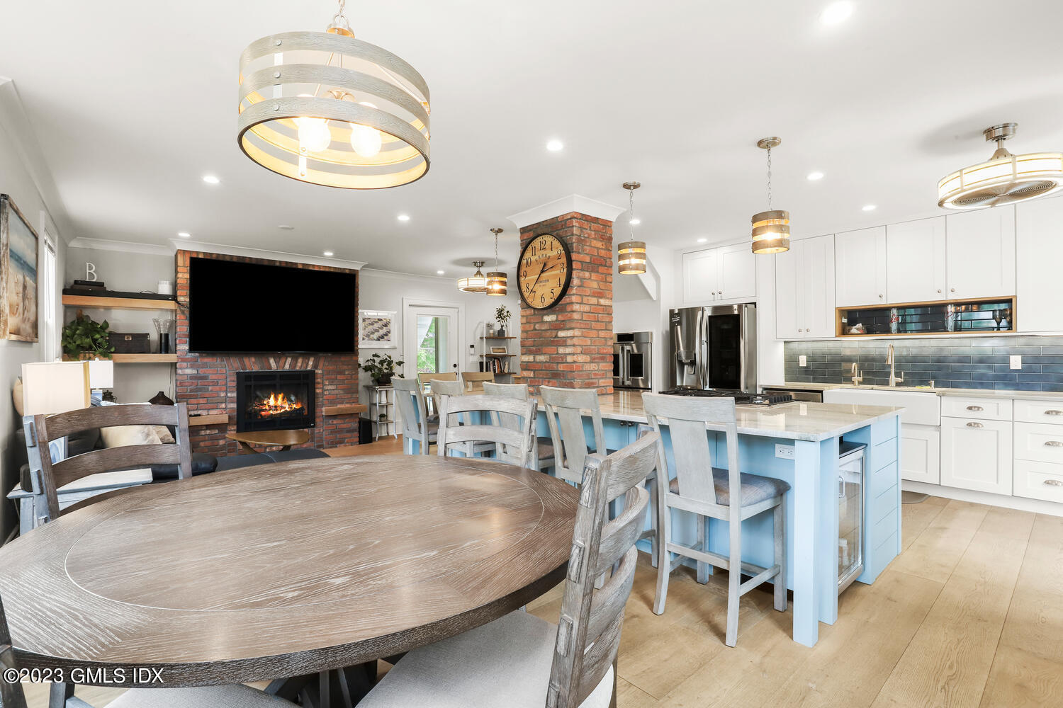 5 Oxer Place Greenwich, CT 06830 - Photo 8 of 37 a kitchen with stainless steel appliances granite countertop a stove a sink a dining table and chairs