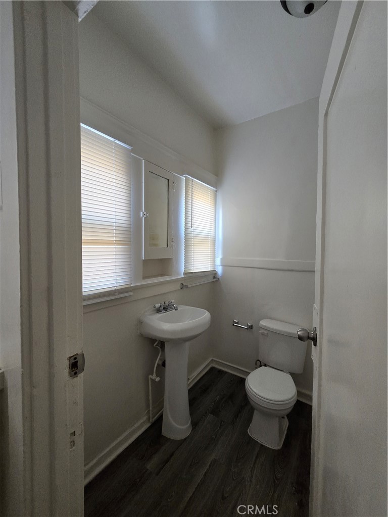 551 West 10th Street, Unit 3 Long Beach, CA 90813 - Photo 15 of 22 a bathroom with a toilet sink and mirror