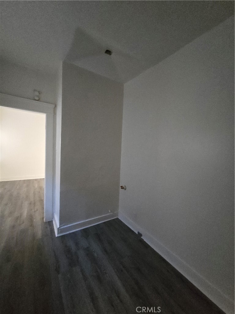 551 West 10th Street, Unit 3 Long Beach, CA 90813 - Photo 20 of 22 an empty room with wooden floor and windows