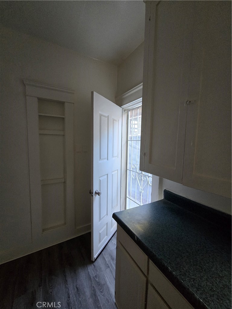 551 West 10th Street, Unit 3 Long Beach, CA 90813 - Photo 22 of 22 an empty room with wooden floor and cabinet