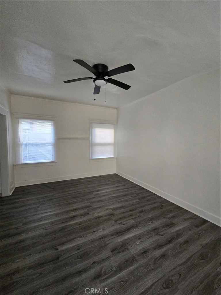 551 West 10th Street, Unit 3 Long Beach, CA 90813 - Photo 9 of 22 an empty room with wooden floor and windows