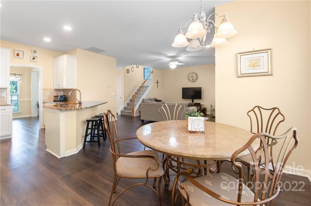 4905 Missi Lane Fort Mill, SC 29708 - Photo 13 of 34 a view of a dining room with furniture and wooden floor