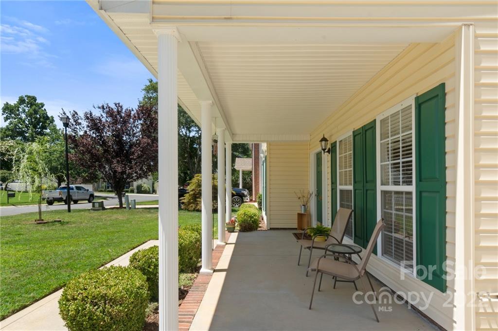 4905 Missi Lane Fort Mill, SC 29708 - Photo 2 of 34 a porch with a table and chairs and a yard