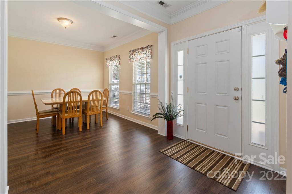 4905 Missi Lane Fort Mill, SC 29708 - Photo 3 of 34 a view of a a dining room with furniture window and wooden floor